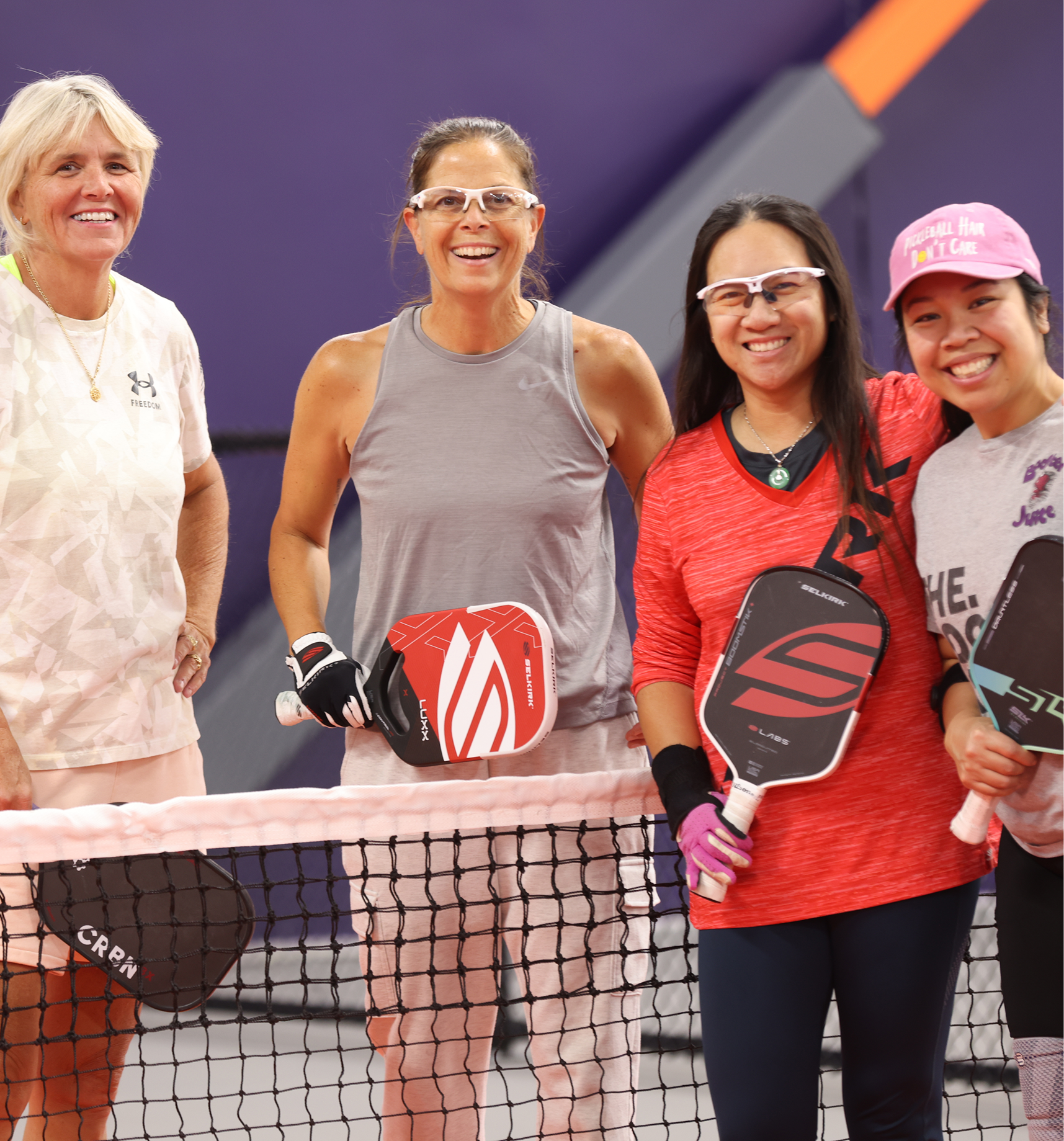 beginners on court, coach with small group, bright room.